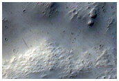 Interactions between Crater Ejecta Mantling Deposits and Flows