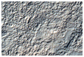 Pit with Well-Exposed Layered Bedrock North of Hellas Region
