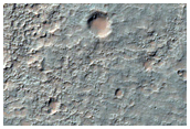 Plains Erosion and Fluidized Ejecta in Tyrrhena Terra