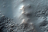 Channel and Trough Interaction North of Warrego Valles
