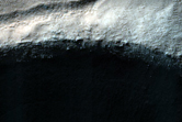 Dark Spot with Light-Toned Outline on Crater Floor