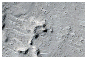 Butte and Mesa-Forming Material in Cratered Highlands Depression
