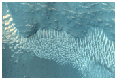 Well-Preserved 2-Kilometer Crater on Steep Slope in Tithonium Chasma
