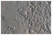 Layers in Mantle along Crater Wall Northeast of Cassini Crater
