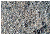 Light-Toned Material Associated with Curvilinear Landform

