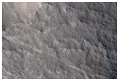 Rounded Deposit at Terminus of Valley Breaching Crater Rim
