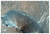 Colorful Layered Bedrock in Eroded Crater in Terra Sirenum
