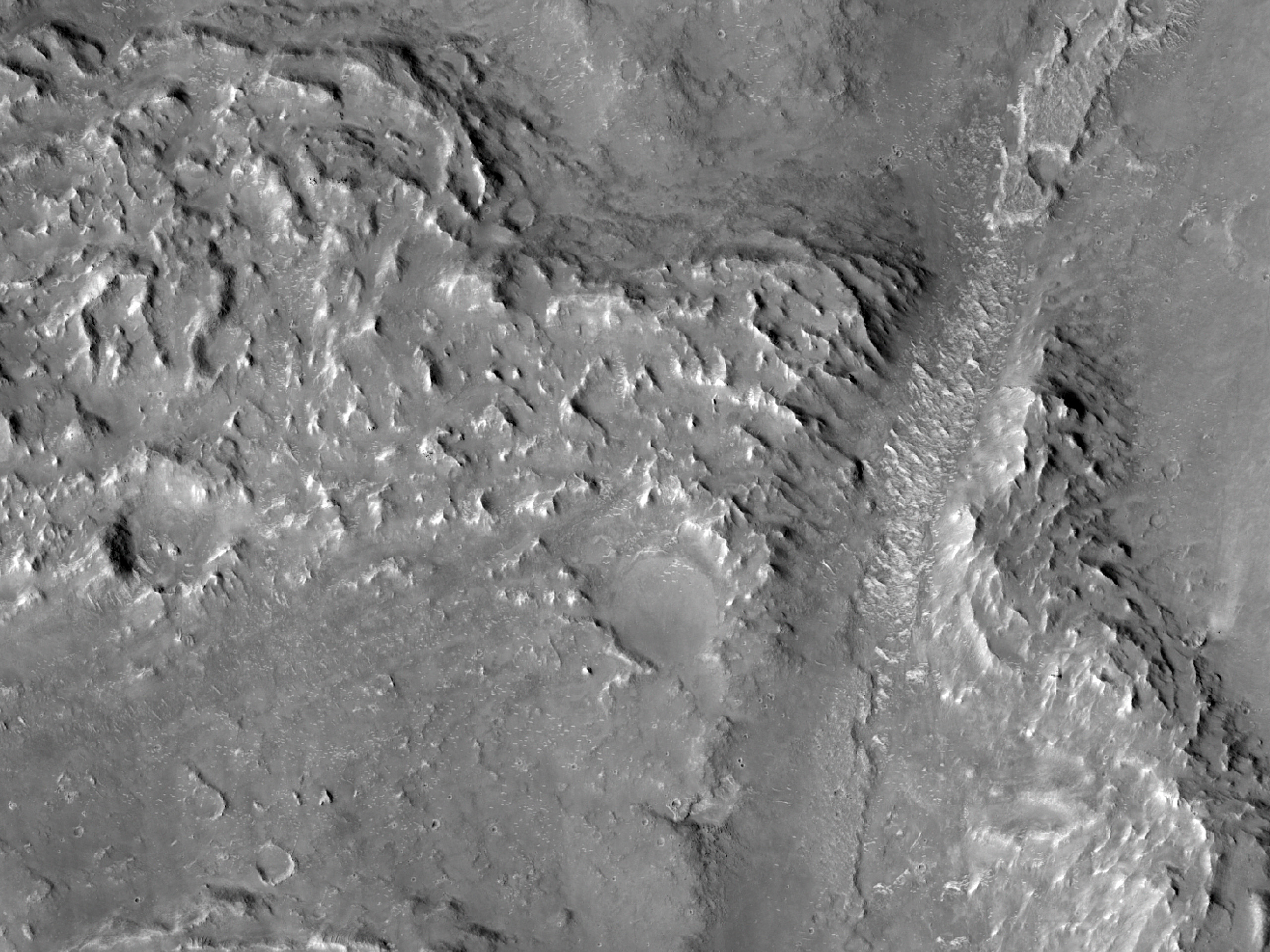 Valley Cutting Ejecta of Crater and Associated Sinuous Ridge