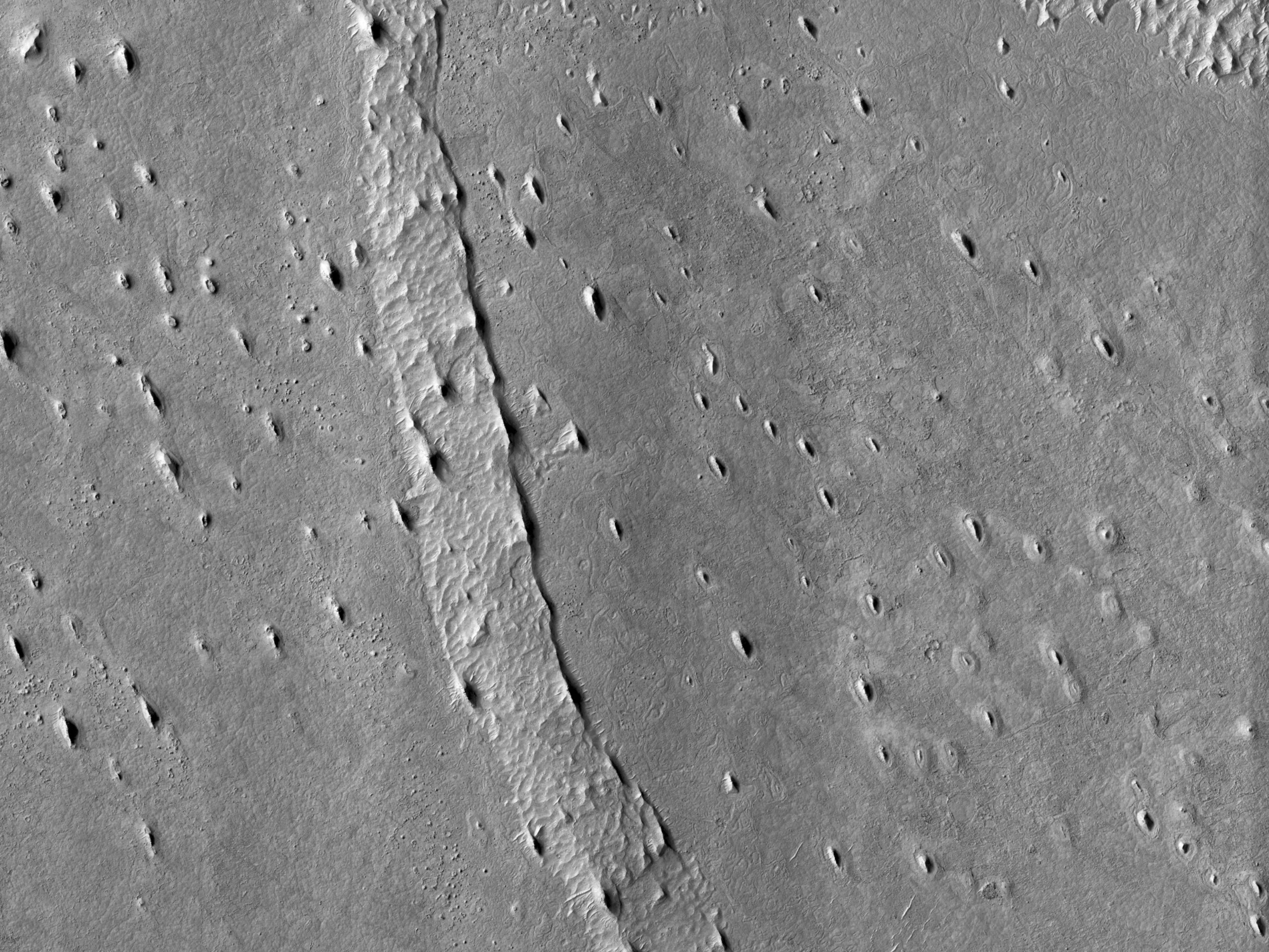 Sinuous Ridge Emergent from beneath Crater Ejecta