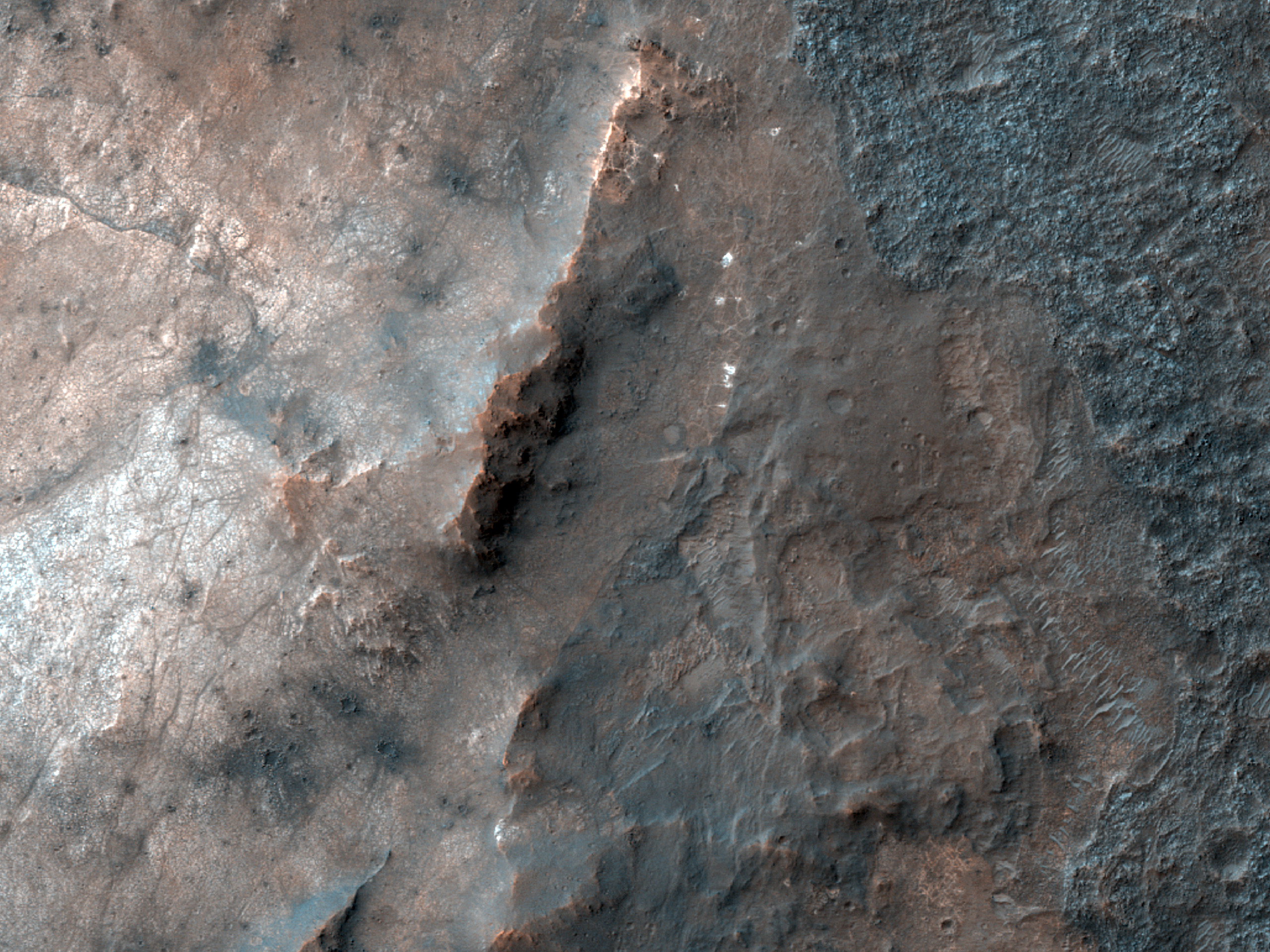Bright Patches on Crater Floor in Thaumasia Planum