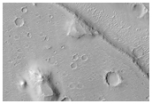 Polygonal Crater Fill Surrounded by Smooth Plains
