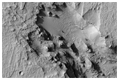 Pit on Crater Floor Which Exposes Layered Deposits