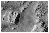 Layered Deposits in Crommlin Crater with Eroded Troughs