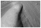 Debris Apron Material Between Crater Rim and Massif in Promethei Terra