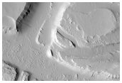 Scoured and Troughed Area Northwest of Jovis Tholus