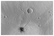 Small Dark Crater and Large Expanse of Dark Rays in North Tharsis Region