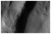 Impact Crater and Possible Related Lava Tube Collapse Features