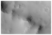 Dark Slope Streaks Along Walls of Naktong Vallis