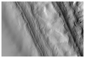 South Polar Layered Deposit Comparison with Higher Latitude Scarps