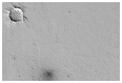 Possible New Impact Crater Formed Between May 2002 and February 2004