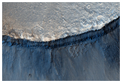 Impact Crater Cut by Ganges Chasma
