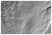 Crater Partially Exhumed by Sublimation in Amphitrites Patera