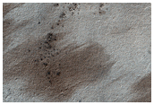 Splotches and Channels Near Sisyphi Montes