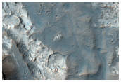 Pit with Well-Exposed Layered Bedrock North of Hellas Region