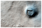Crater and Ridge in Dorsa Argentea