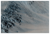 Oblique Impact Exposing Bedrock within A Libya Montes Massif