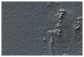 Mantled Crater in Promethei Terra
