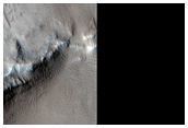 Layers and Terraces in Crater Near Gigas Fossae