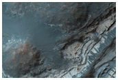 Light-Toned Layered Rock Outcrops North of Hellas Region
