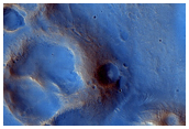 Unusual Dark Albedo Feature in A Dust-Starved Area