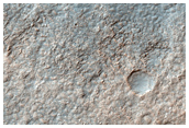 Big Crater in Hellas Basin with Channels Flowing In and Out