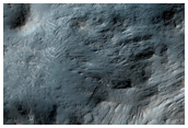 Layered Bedrock Exposed in Central Uplift of Crater in Thaumasia Planum