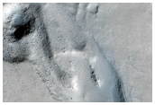 Wrinkle Ridge Cut by Theater-Headed Channels in Memnonia Fossae