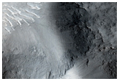 Ejecta Intersecting the Crater Rim in a Small Unnamed Crater