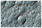 Light-Toned Surface in Rugged Terrain North of Icaria Planum