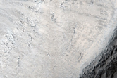 Crater Exposing Layered Stratigraphy of Northern Plains