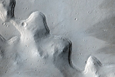 Smooth Crater Floor with Bounding Terrace on Flank of Uranius Mons