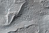 Flow-Like Features Possibly From Layered Ejecta of a Nearby Crater