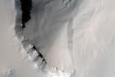 Layered Outcrop and Associated Boulder Tracks North of Pavonis Mons