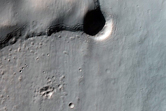 Relatively Flat Crater Floor Bounded By Sharp Change in Slope