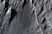 Exposure of Light-Toned Layering along Wallrock in Coprates Chasma