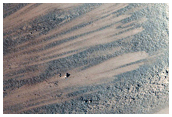 Oblique Impact Exposing Bedrock within a Libya Montes Massif