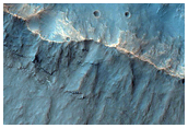 Crater with Light-Toned Ejecta in the Wall of a Larger Crater