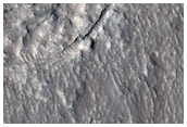 Unusual Crater on Lobate Deposits North of Hrad Vallis