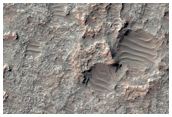 Eroded Layered Material on Floor of Large Old Crater