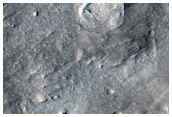 Crater Ejecta Among Knobs and Buttes